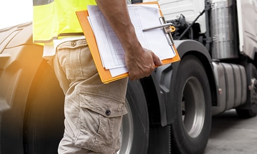 Katlaw CDL graduate beside semi truck
